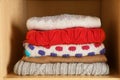Stack of folded winter clothes on shelf Royalty Free Stock Photo