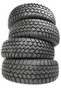 Stack of four car wheel winter tires isolated Royalty Free Stock Photo