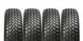 Stack of four car wheel winter tires isolated Royalty Free Stock Photo