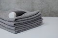 A stack of four gray towels in the bathroom
