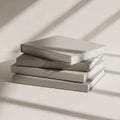 A stack of four hardcover books with plain, light gray covers rests on a white surface. They are Royalty Free Stock Photo