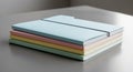 Stack of four pastel-colored document folders (blue, pink, yellow, green) neatly Royalty Free Stock Photo