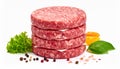 Stack of Four Raw Burger Patties with Lettuce, Tomato, Basil, and Spices on White Background Royalty Free Stock Photo