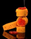 A stack of four rectangular soap bars, some with visible honeycomb designs, are drizzled with honey, creating a luxurious and