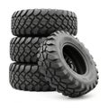 Stack of Four Rugged Off- Road Tires with Aggressive Tread Patterns Royalty Free Stock Photo