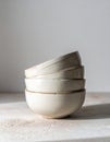 Stack of Four White Ceramic Bowls on Textured Surface in Bright Studio Light Royalty Free Stock Photo