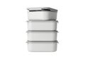 Stack of four white rectangular food storage containers with lids Royalty Free Stock Photo