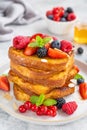 A stack of French toast on a plate with fresh berries, almond petals and honey on a gray concrete background. Delicious breakfast Royalty Free Stock Photo