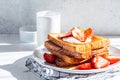 A stack of French toast with strawberries, yogurt and maple syrup. Breakfast concept Royalty Free Stock Photo