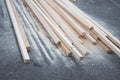 Stack of Fresh Cut Wooden Beams with Sawdust on Asphalt Surface Royalty Free Stock Photo