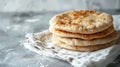 Stack of fresh flatbreads on a white textured background with cloth Royalty Free Stock Photo