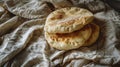 Stack of fresh flatbreads on a white textured background with cloth Royalty Free Stock Photo