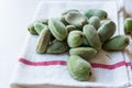 Stack of Fresh Green Almond Nut Fruits on tablecloth. Royalty Free Stock Photo