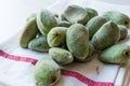 Stack of Fresh Green Almond Nut Fruits on tablecloth. Royalty Free Stock Photo