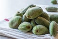 Stack of Fresh Green Almond Nut Fruits on tablecloth. Royalty Free Stock Photo