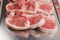 Stack of fresh lamb loin chops. Close up. Meat industry. The product is on a metal tray, Butcher craft