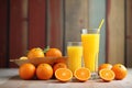 stack of fresh oranges, glass of juice on side