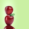 Stack of fresh ripe red apples on pastel green background, space for text Royalty Free Stock Photo