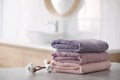 Stack of fresh towels and cotton flowers on table Royalty Free Stock Photo