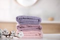 Stack of fresh towels and cotton flowers on table Royalty Free Stock Photo