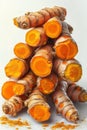 Stack of fresh turmeric roots on a white background, suitable for culinary or health-related themes. Royalty Free Stock Photo