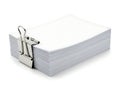 A stack of fresh white paper secured tightly with a large metal binder clip on a white background Royalty Free Stock Photo