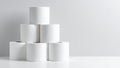 Stack of fresh white toilet paper rolls arranged in a pyramid shape on a white surface Royalty Free Stock Photo