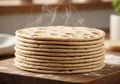 A stack of freshly baked flatbreads is on a wooden surface, Royalty Free Stock Photo