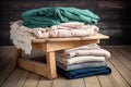 stack of freshly laundered and folded linens on wooden table