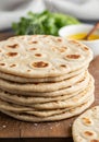 A stack of freshly made flatbreads is placed on a wooden surface. The flatbreads Royalty Free Stock Photo