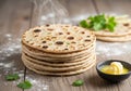 A stack of freshly made Indian flatbreads, likely parathas, is placed Royalty Free Stock Photo