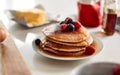 Stack Of Freshly Made Pancakes Or Crepes With Maple Syrup And Berries On Table For Pancake Day Royalty Free Stock Photo