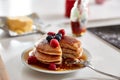 Stack Of Freshly Made Pancakes Or Crepes With Maple Syrup And Berries On Table For Pancake Day Royalty Free Stock Photo