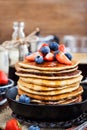 Stack of freshly prepared banana pancakes with fresh berries Royalty Free Stock Photo