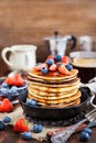 Stack of freshly prepared banana pancakes with fresh berries Royalty Free Stock Photo