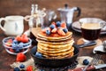 Stack of freshly prepared banana pancakes with fresh berries Royalty Free Stock Photo