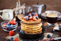 Stack of freshly prepared banana pancakes with fresh berries Royalty Free Stock Photo