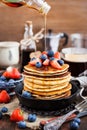 Stack of freshly prepared banana pancakes with fresh berries Royalty Free Stock Photo
