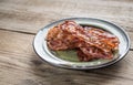 Stack of fried bacon strips on the plate Royalty Free Stock Photo