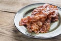 Stack of fried bacon strips on the plate Royalty Free Stock Photo