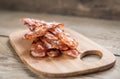 Stack of fried bacon strips on the wooden board Royalty Free Stock Photo