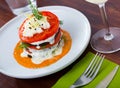 Stack of fried eggplant with tomatoes and piquant sauce