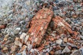 Stack of frosted old, used, perforated bricks and pieces of wall