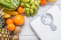 Stack of fruits and white weight scale