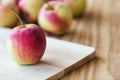 Stack of fuji apple and on cutting board put on wood table for b Royalty Free Stock Photo