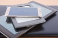 Stack of gadgets on a desk - notebook, tablet, ebook reader and Royalty Free Stock Photo