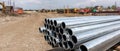 Stack of shiny galvanized steel pipes at outdoor construction site Concept of industrial material, infrastructure development, and Royalty Free Stock Photo