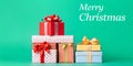 Stack of Beautifully Wrapped Christmas Presents on a Teal Background Royalty Free Stock Photo