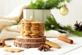 Stack of ginger cookies and spices on wooden tabletop