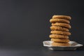 A stack of gingerbread cookies on a white plate with a black background Royalty Free Stock Photo